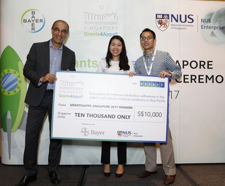 Dr Kemal Malik, Member of the Board of Management, Bayer AG, with EyeDEA, winning team from Singapore.jpg